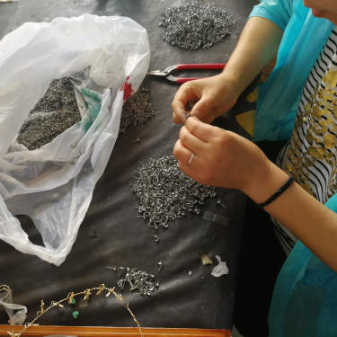 Earrings in the hands of QC person