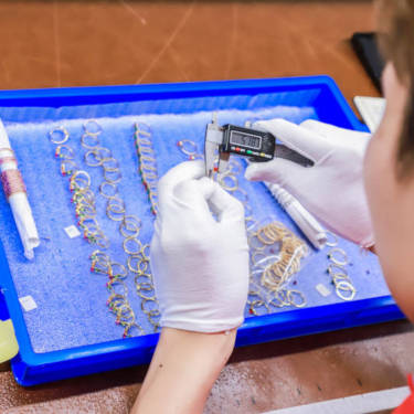 Man using calipers to measure jewelry
