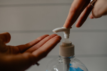 Hands receiving hand sanitzer