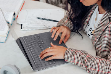 woman typing on computer at a table