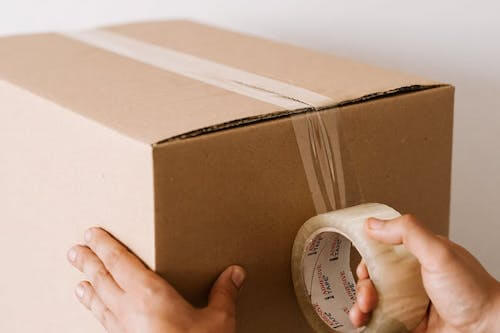 Person taping a box