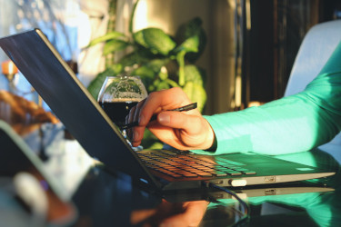 Young professional filling out a form on their laptop