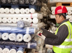 Man inspecting textiles in a factory
