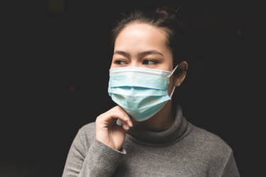 Woman wearing surgical mask - Insight Quality Services