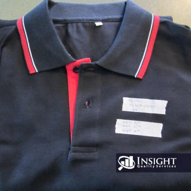 Blue and red polo shirt with stickers for inspection