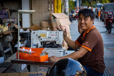 Indonesian man with a sewing machin