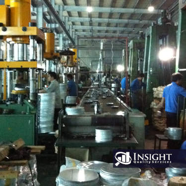 The inside of a factory stamping metal bowls