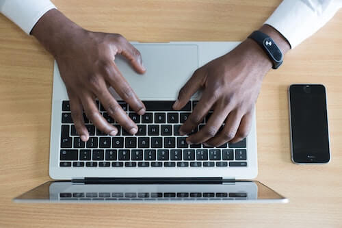 Professional typing on a keyboard when dealing with sourcing agent