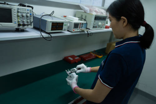 Inspector measuring product during pre-shipment inspection