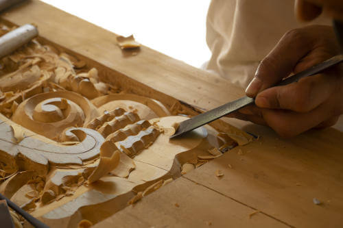 Thai craftsman carving wood