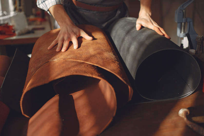 Man in studio working with leather