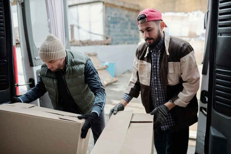 Warehouse workers handling cartons