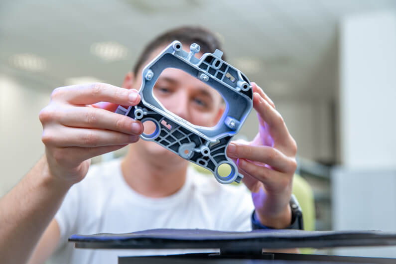 Man examining a golden sample