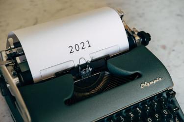 A typewriter with a paper that says 2021 coming out of it