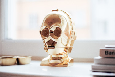 Gold-colored C-3PO head sitting on a desk