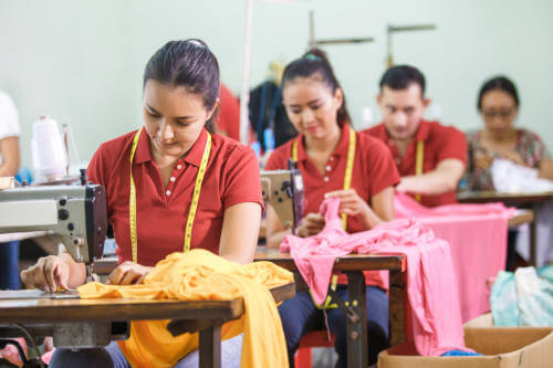 Factory workers sewing in workshop