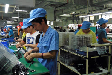Factory workers inside electronics factory