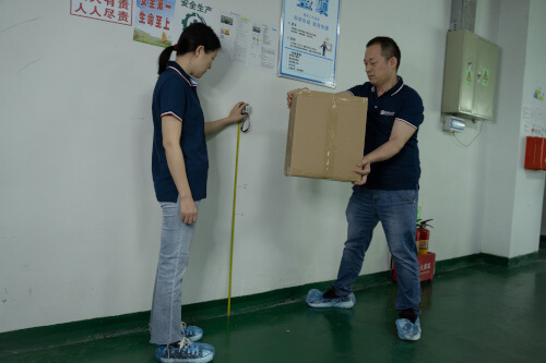 Product quality inspectors conducting a carton drop test