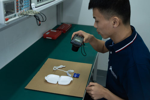 Product inspector photographing a tooth whitening kit during inspection
