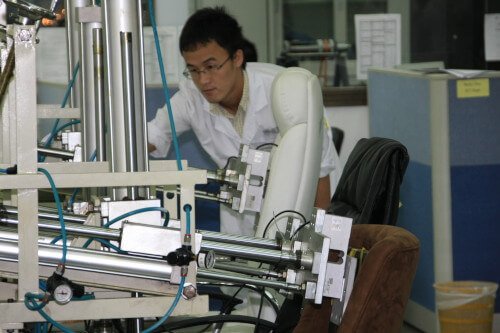 Lab technician conducting tests on chairs