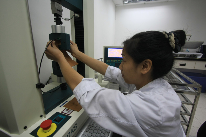 Woman lab testing fabric