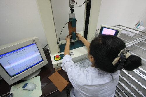 Lab technician conducting test on fabric