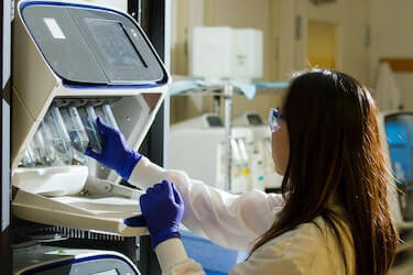 Woman using medical lab equipment