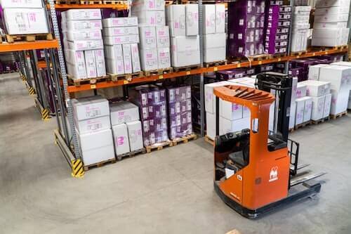 Forklift in warehouse full of cartons