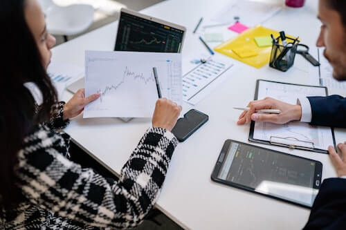 Two people discussing graph