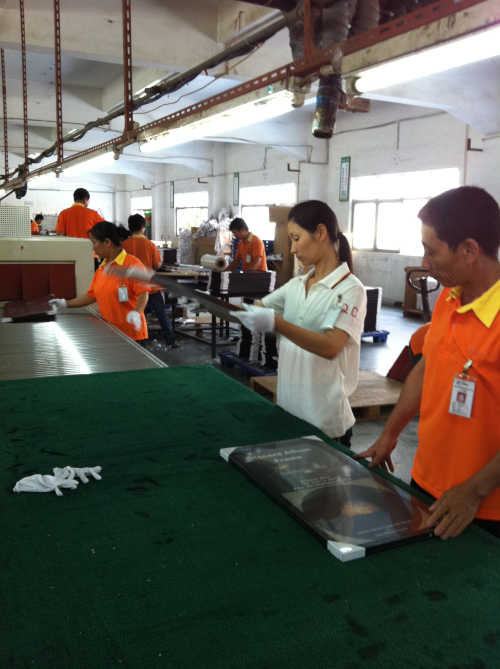 QC inspector examining a picture frame in factory