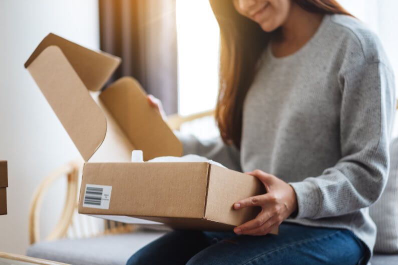 Woman looking at product and smiling