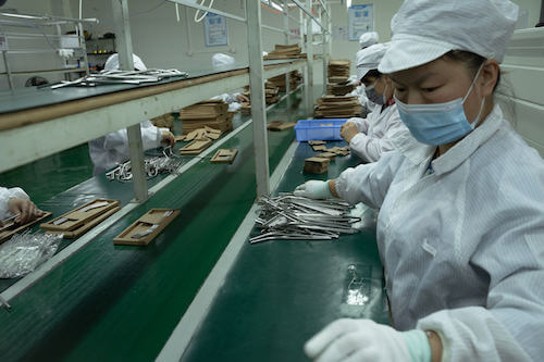 Woman working in factory before Chinese New Year factory shutdown 2022