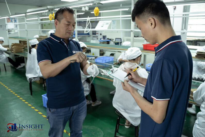 Inspectors measuring metal straws with calipers