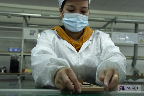 Factory worker in Shenzhen assembling a product