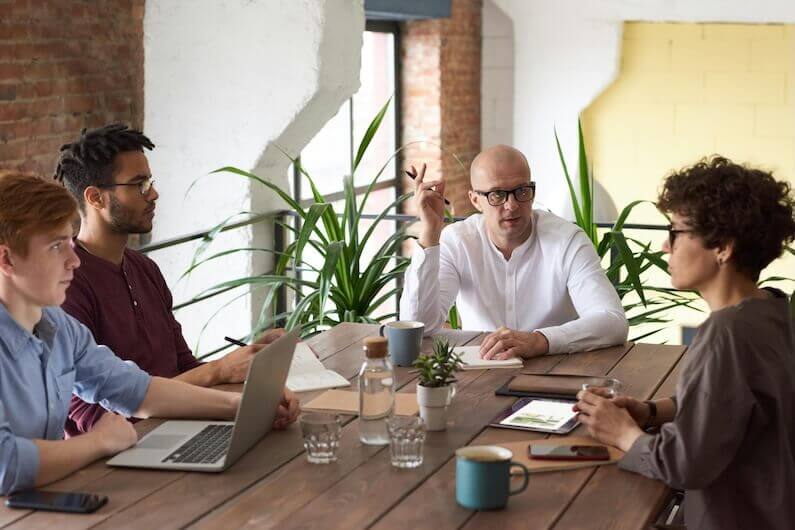 Four employees in a business meeting