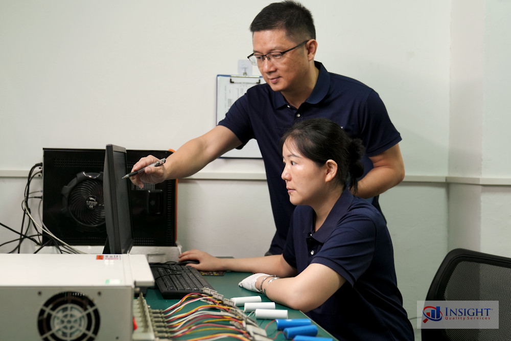 Insight inspectors (Kevin & Linna) examining data on a factory monitor